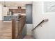 Wooden staircase with metal railing leading to the kitchen at 14870 W Encanto Blvd # 2090, Goodyear, AZ 85395