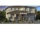 Two-story house with stone accents and a three-car garage at 20578 E Via De Colina --, Queen Creek, AZ 85142