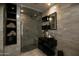 Modern bathroom with glass shower, floating vanity, and stone tile at 118 E Palm Ln, Phoenix, AZ 85004