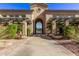 Inviting community entrance with archway, pergola, and lush landscaping at 16013 S Desert Foothills Pkwy # 1122, Phoenix, AZ 85048