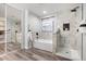 Elegant bathroom with marble tile and soaking tub at 15163 W Cameron Dr, Surprise, AZ 85379