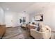 Open living space with comfortable sofas, a coffee table, and hardwood floors at 15163 W Cameron Dr, Surprise, AZ 85379