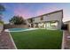 Backyard oasis with a swimming pool and artificial turf at 15163 W Cameron Dr, Surprise, AZ 85379