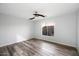 Bright bedroom featuring wood flooring and large window at 15163 W Cameron Dr, Surprise, AZ 85379