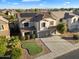 Two-story house with solar panels, a large driveway, and a landscaped yard at 15163 W Cameron Dr, Surprise, AZ 85379