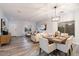 Bright dining area with a modern table, chairs, and hardwood floors at 15163 W Cameron Dr, Surprise, AZ 85379