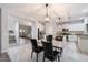 Open kitchen with island and view into living room at 15163 W Cameron Dr, Surprise, AZ 85379