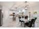Modern kitchen with white cabinets, granite countertops, and a kitchen island at 15163 W Cameron Dr, Surprise, AZ 85379