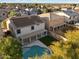 Aerial view of house with pool and solar panels at 15163 W Cameron Dr, Surprise, AZ 85379