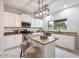 Well-equipped kitchen featuring granite countertops and white cabinetry at 15163 W Cameron Dr, Surprise, AZ 85379