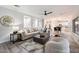 Open-concept living room with a sectional sofa and stylish decor at 15163 W Cameron Dr, Surprise, AZ 85379