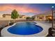 Enjoy sunsets by the kidney-shaped pool with patio furniture at 1356 E Loveland Ln, San Tan Valley, AZ 85140