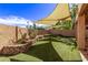 Private backyard with artificial turf and shade sails at 3047 E Fremont Rd, Phoenix, AZ 85042