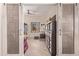 Home office with barn doors, built-in shelving, and ample natural light at 3047 E Fremont Rd, Phoenix, AZ 85042