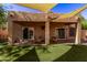 Covered patio with seating area, providing shade and a relaxing outdoor space at 3047 E Fremont Rd, Phoenix, AZ 85042