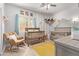 Charming Bedroom with two cribs, a rocking chair, and playful decor at 3047 E Fremont Rd, Phoenix, AZ 85042