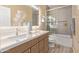 bathroom with dual sinks, a bathtub, and a large shower at 3047 E Fremont Rd, Phoenix, AZ 85042