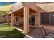 Relaxing covered patio with seating area and artificial turf at 3047 E Fremont Rd, Phoenix, AZ 85042