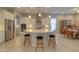 Island kitchen with white cabinets and breakfast area at 27552 W Tonopah Dr, Buckeye, AZ 85396