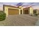 Two-car garage with paver driveway and landscaping at 27552 W Tonopah Dr, Buckeye, AZ 85396