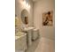 Elegant powder room with pedestal sink and artistic wall decor at 27552 W Tonopah Dr, Buckeye, AZ 85396