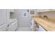 Laundry room with built-in cabinets and a large countertop at 27552 W Tonopah Dr, Buckeye, AZ 85396