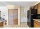 Kitchen features wood cabinets, black appliances, and a pantry at 4019 E Calypso Ave, Mesa, AZ 85206