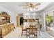 Charming dining room with wood table and access to the kitchen and patio at 4019 E Calypso Ave, Mesa, AZ 85206
