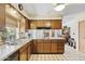 Efficient kitchen with wood cabinets and ample counter space at 4019 E Calypso Ave, Mesa, AZ 85206