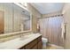 Full bathroom with tub and shower, vanity and updated mirror at 4019 E Calypso Ave, Mesa, AZ 85206