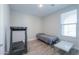 Small bedroom with a twin bed, treadmill and window at 9515 E Rainbow Ave, Mesa, AZ 85212