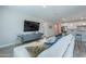 Bright living room features a large sectional sofa, hardwood floors, and open concept to kitchen at 9515 E Rainbow Ave, Mesa, AZ 85212