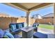 Covered patio with seating area and artificial turf at 9515 E Rainbow Ave, Mesa, AZ 85212