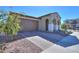 Front view of a house with a brown garage door and a landscaped yard at 9515 E Rainbow Ave, Mesa, AZ 85212