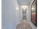 Long hallway with light walls and wood floors at 9515 E Rainbow Ave, Mesa, AZ 85212