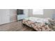 Bright bedroom with wood-look floors and a large window at 9515 E Rainbow Ave, Mesa, AZ 85212