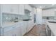 Modern kitchen with white cabinets, quartz countertops and a gas cooktop at 9515 E Rainbow Ave, Mesa, AZ 85212
