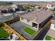 Single-story house with artificial turf backyard and a wooden fence at 9515 E Rainbow Ave, Mesa, AZ 85212