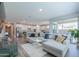 Spacious living room with an open floor plan, L-shaped sofa and view into the kitchen at 9515 E Rainbow Ave, Mesa, AZ 85212