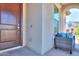 House entrance with a brown door and outdoor seating at 9515 E Rainbow Ave, Mesa, AZ 85212