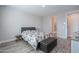 Primary bedroom with queen bed, en-suite bathroom access, and wood-look floors at 9515 E Rainbow Ave, Mesa, AZ 85212