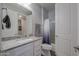 Clean bathroom with granite countertop, white cabinets, and a bathtub at 9515 E Rainbow Ave, Mesa, AZ 85212