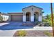 Single-story home with arched entryway and two-car garage at 9515 E Rainbow Ave, Mesa, AZ 85212