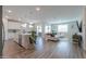 Open concept kitchen and living room with hardwood floors and modern appliances at 9515 E Rainbow Ave, Mesa, AZ 85212