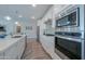 Modern kitchen with stainless steel appliances and white cabinets at 9515 E Rainbow Ave, Mesa, AZ 85212