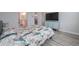 Primary bedroom with a queen bed, wood-look floors, and teal cabinet at 9515 E Rainbow Ave, Mesa, AZ 85212