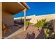 Landscaped backyard with a patio, stone path, and desert plants at 2101 S Meridian Rd # 172, Apache Junction, AZ 85120
