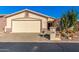 Desert landscape surrounds this single-story home with a two-car garage at 2101 S Meridian Rd # 172, Apache Junction, AZ 85120