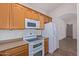 Kitchen with oak cabinets, white appliances, and tile floor at 2101 S Meridian Rd # 172, Apache Junction, AZ 85120