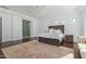 Bright bedroom with king bed, hardwood floors, and access to the ensuite bathroom at 22474 S 199Th Cir, Queen Creek, AZ 85142